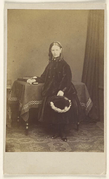 young girl curls standing holding hat resting