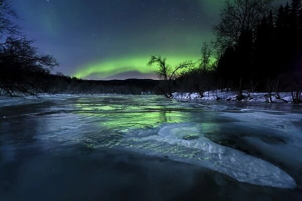 Aurora Borealis over a frozen Kvannelva River, Troms, Norway