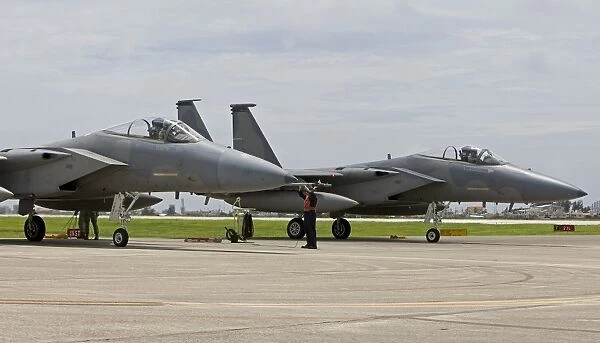 Two F-15s parked at the end of runway at Kadena Air Base, Japan