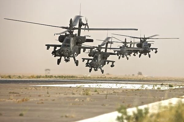 A group of AH-64D Apache helicopters landing on the runway