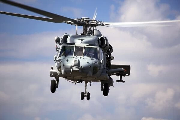Navy pilots in a SH-60F Seahawk conduct final approach for landing