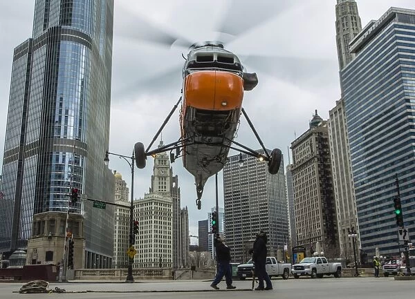 An S-58T helicopter comes down to street level in Chicago, Illinois