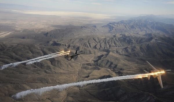 A two ship of B-1B Lancers release chaff and flares while maneuvering over New Mexico
