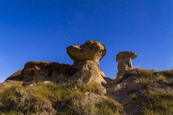 Starry sky above hoodoo formations at Dinosaur Provincial Park, Canada