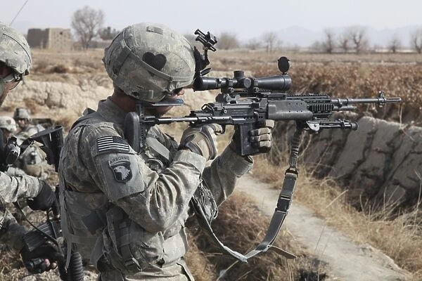 A U. S. Army soldier looks through the scope of his M-14 sniper rifle