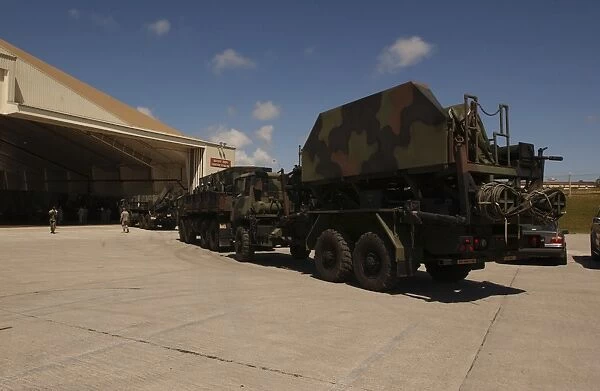U. S. Soldiers transport Patriot Advanced Capability missiles into a hangar
