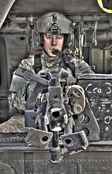 A UH-60 Black Hawk door gunner manning a M240G medium machine gun