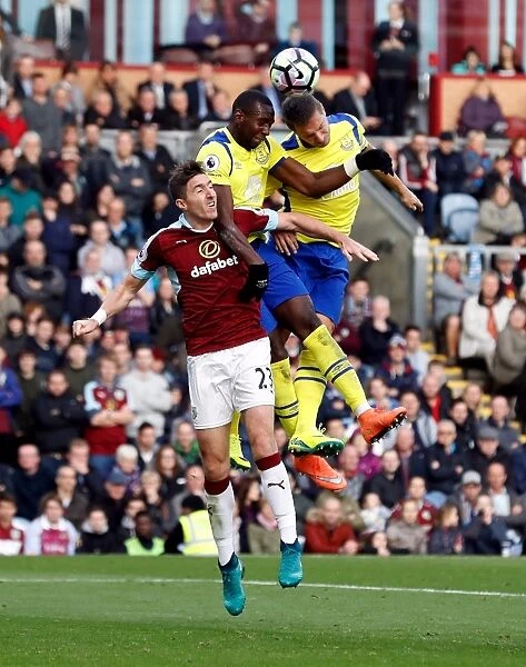 Clash at Turf Moor: Jagielka and Bolasie Battle Ward for Ball Control in Everton vs Burnley Premier League Encounter