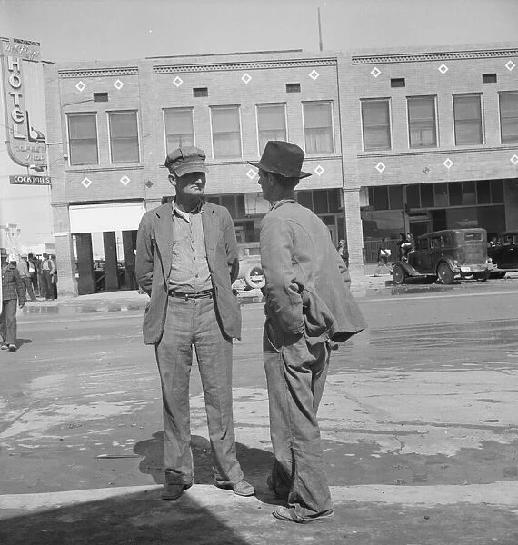 Idle pea pickers discuss prospects for work, Calipatria, Imperial Valley, CA, 1939. Creator: Dorothea Lange