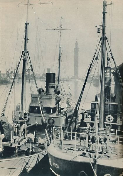 Naval Trawler, HMS Liffy alongside a Grimsby fishing vessel in Grimsby Docks, 1937