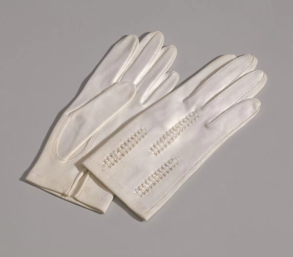 Pair of light cream gloves with openwork design from Maes Millinery Shop, 1941-1994