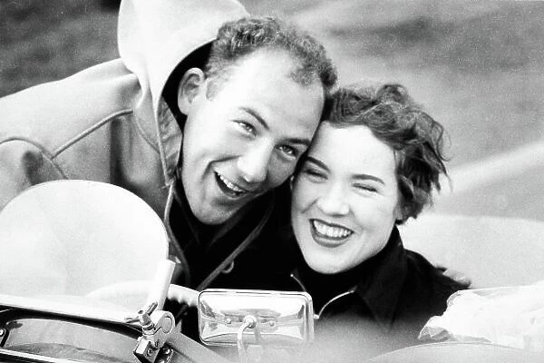 1955 Ladies handicap race. Goodwood, West Sussex, Great Britain. 26 March 1955. Stirling Moss congratulates his sister Pam after she finished in 1st position in a MG TF, portrait. World Copyright: LAT Photographic Ref: Autosport b&w print