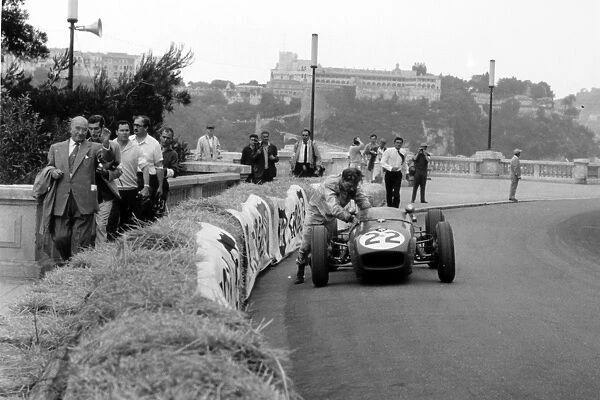 1960 Monaco Grand Prix - Innes Ireland: Innes Ireland, Lotus 18-Climax, 9th position, pushes his car around almost a complete lap to finish, action