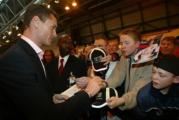 Autosport International Show: McLaren driver David Coulthard signs autographs for fans on the F1 Racing stand