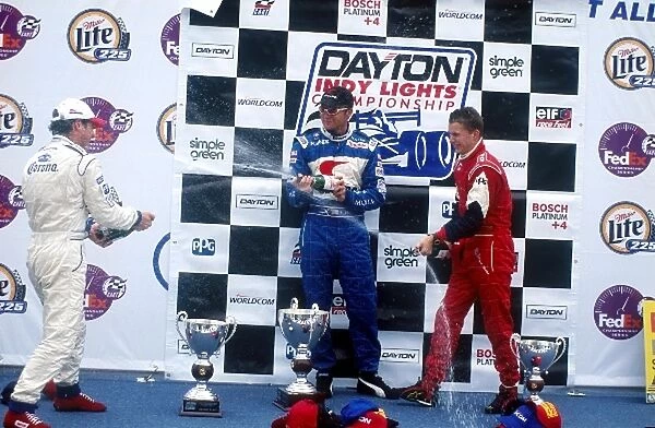 Dayton Indy Lights: Race winner Townsend Bell celebrates with 2nd place Mario Dominguez, left, and 3rd place Daniel Wheldon, right