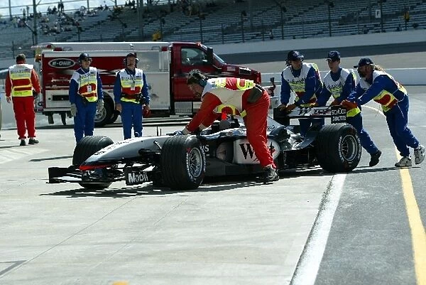 Formula One World Championship: A McLaren is pushed into parc ferme during qualifying