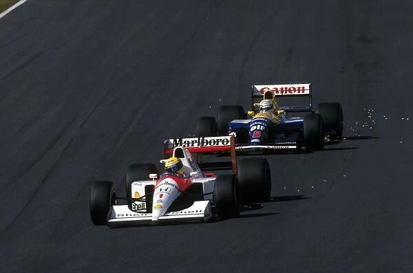Formula One World Championship: Nigel Mansell following Ayrton Senna closely at Suzuka
