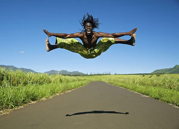 Hawaii, Kauai, Kealia, African Dancer Leaping Into The Air On Country Road