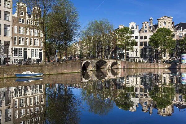 Stone bridge crossing the Herengracht on a sunny day in Amsterdam, Holland