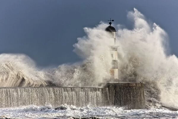 Waves Crashing Up Against A Lighthouse; Seaham, Teesside, England