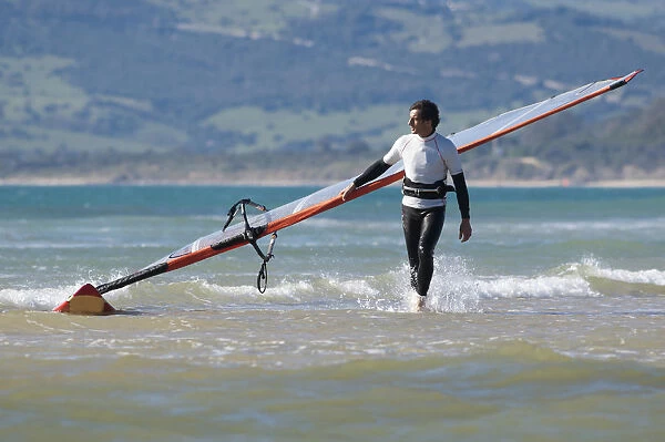 Windsurfer Carrying Surfboard; Los Lances Beach Tarifa Spain