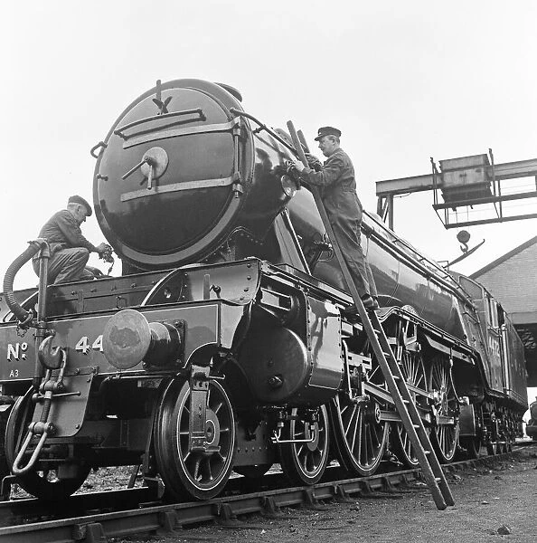 Alan Pegler, (right on his ladder), cleans and polishes The Flying Scotsman