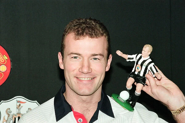 Alan Shearer holding his soccer figure from the Soccer Superheroes collection