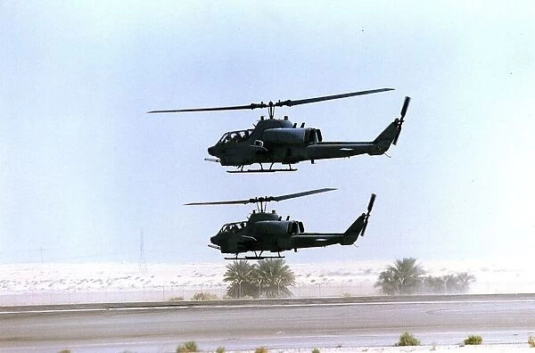 Two allied Cobra helicopter gunships seen here leaving a Saudi Airforce desert airfirld
