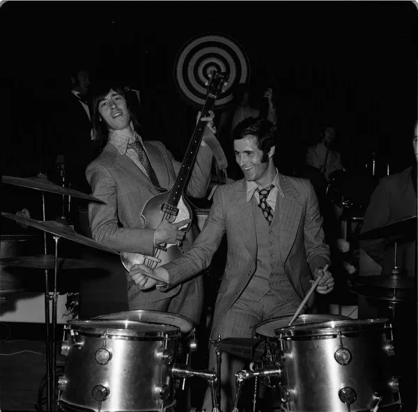 Arsenal footballers George Graham and Charlie George dressed in 1960s style clothing