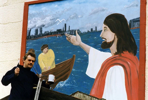 Art student Gary McNamara with the mural he has painted above the entrance to St Pius