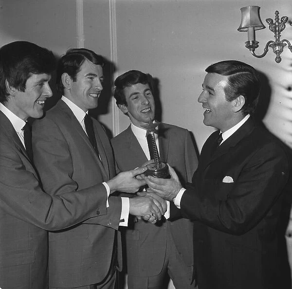 The Bachelors pop group with disc jockey Alan Freeman 1964 being presented with their