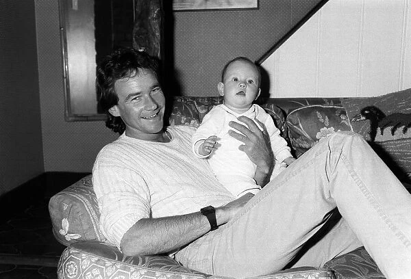 Barry Sheene at home with baby daughter Sidonie, May 1985