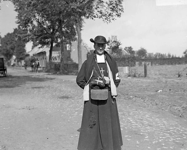 The Battle of Hofstade. A Belgian Red Cross priest with pieces of bread suspended