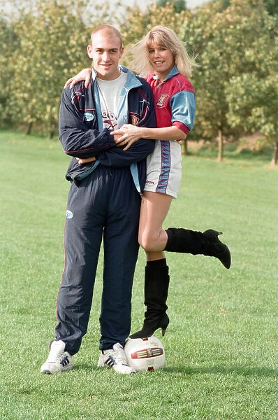 BBC Radio WM presenter Julie Mayer in an Aston Villa kit with Villa midfielder Mark