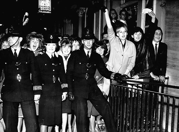Beatles fans screaming outside the Palladium as they await the arrival of their idols