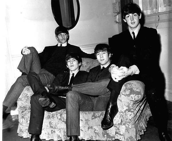 The Beatles sitting on a sofa during their visit to Newcastle