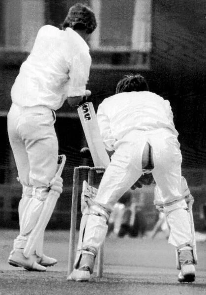 Cambridge University wicket keeper Peter Cottrell having some trouser problems during