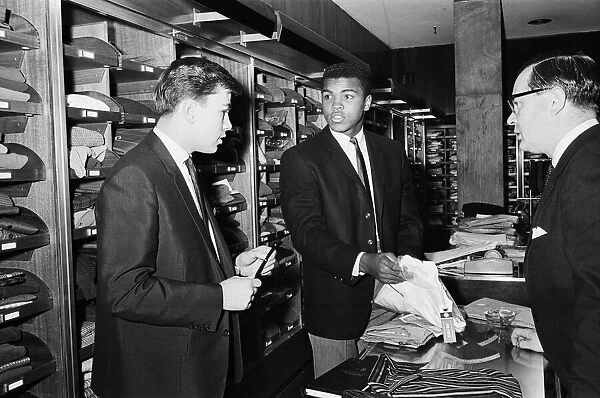Cassius Clay aka (Muhammad Ali) getting measured at Austin Reeds in London'