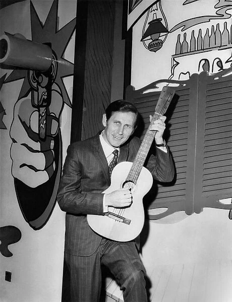 Chet Atkins with a guitar he brought with him to present to the Nashville Room
