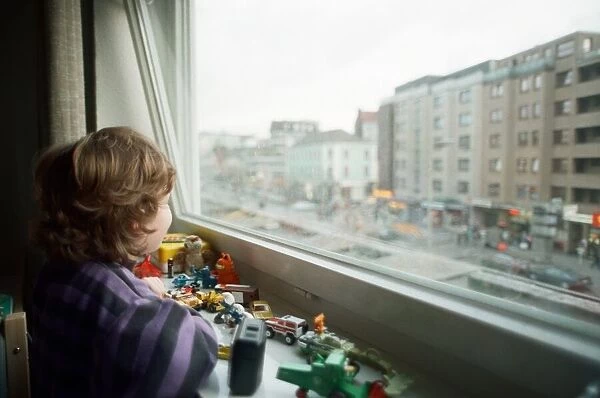 Child looks through window with view of Red light district in Hamburg, West Germany