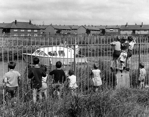 Children looking at the Leeds and Liverpool Canal. July 1968