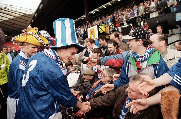 David Robertson Rangers football player with Ian Durrant both wearing hats greet the fans