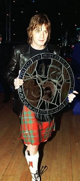 Ewan McGregor actor carrying award Scottish Peoples Film Festival 1997 round targe like