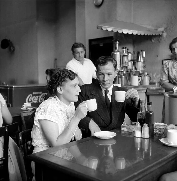 Food: Eating out: Couple in cafe in the West End of London. August 1953 D5148