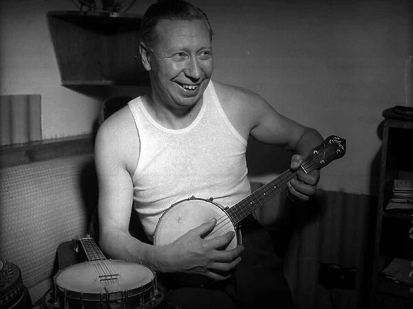 George Formby comedian actor playing his ukulele in 1953 A©mirrorpix