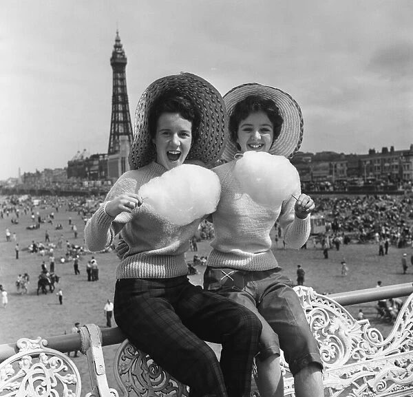 Jean Clark and Mary Cuppler enjoy eating candy floss on the pier at Blackpool, Lancashire