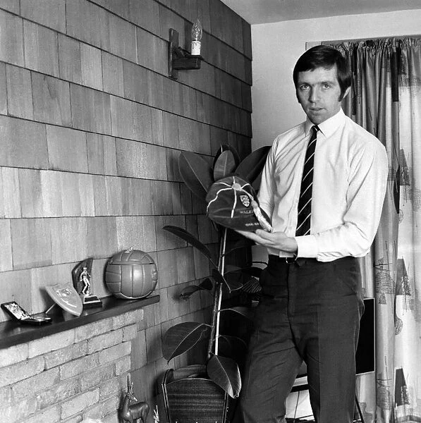 Jeff Astle pictured at home, with some of his trophies and one of his England caps