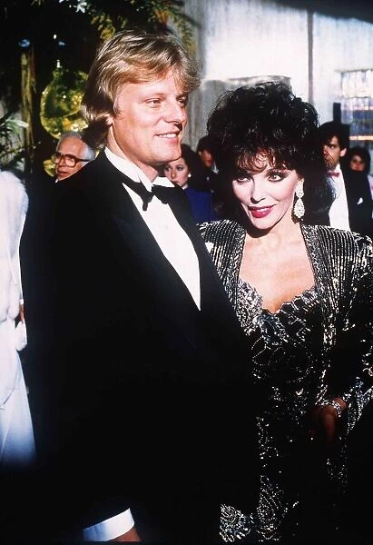 Joan Collins with her new man Malcolm Frazer at a film Premiere at the Odeon Leicester