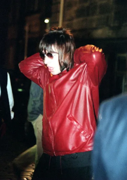 Liam Gallagher of Oasis at the Edinburgh Festival wearing a red leather jacket