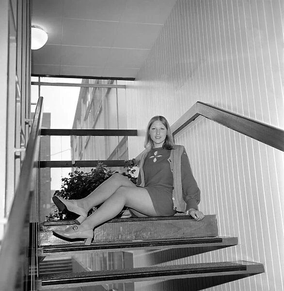Linda Sewell aged 18 wearing a mini skirt sitting on the steps December 1969